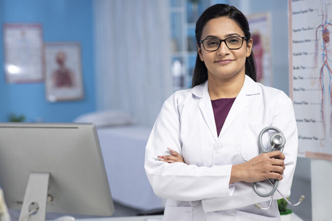 Female Doctor arm crossed confidence stock photo