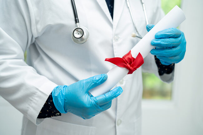 Doctor holding diploma medical degree in hospital, congratulations on success in graduation.