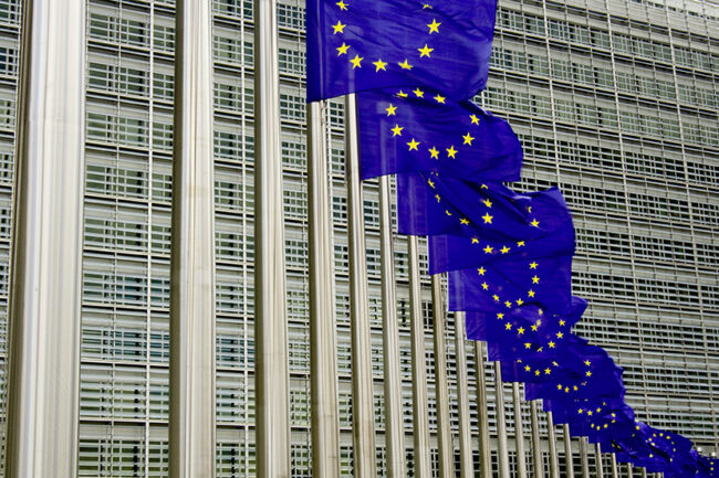 EU flags in Brussels against building