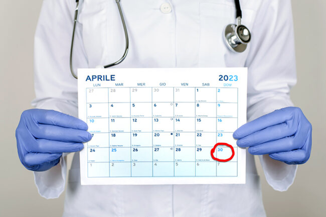 Prevention consultation concept. Cropped close up photo of person nurse holding calendar in hands isolated over grey color background