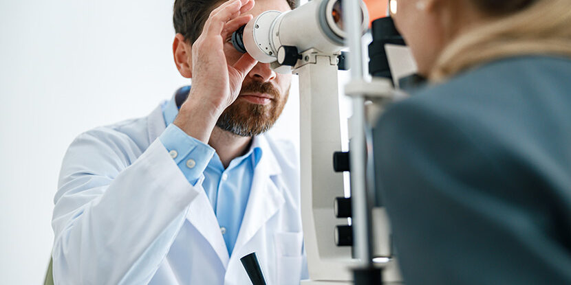 Optometrist checks the patient’s intraocular pressure in optician’s shop or ophthalmology clinic